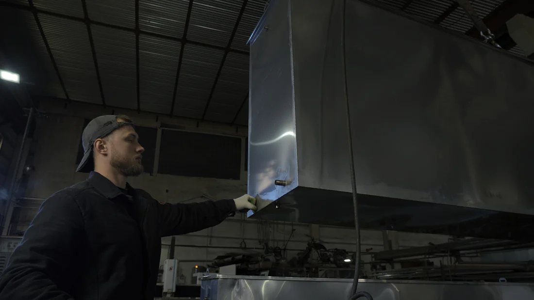 Best Wash technician handling stainless steel equipment on a job in Central PA